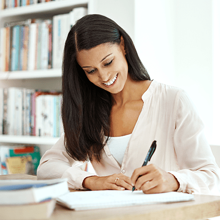 woman writing at desk