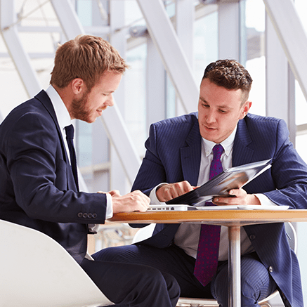 two men in looking at document