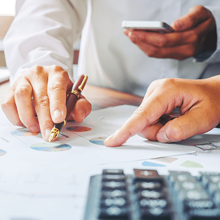 hands pointing to graphs on chart