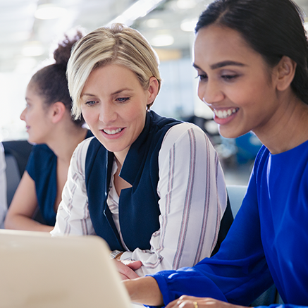 two women looking at laptop