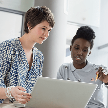 two women looking at laptop