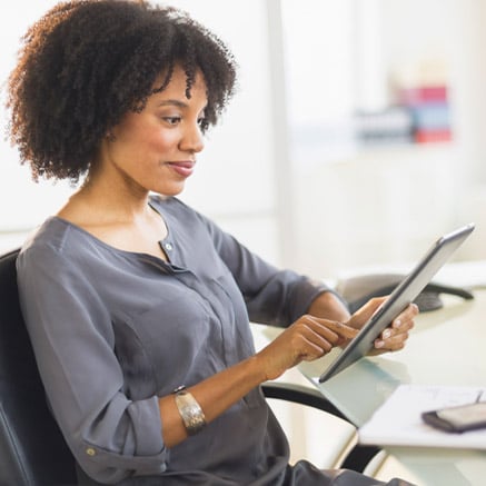 woman looking at tablet