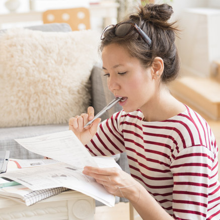 woman looking at loan papers